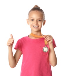 Photo of Happy girl with golden medal on white background