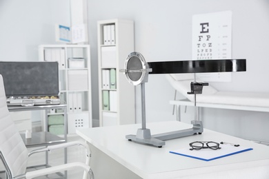 Photo of Campimeter on table in clinic. Ophthalmic equipment