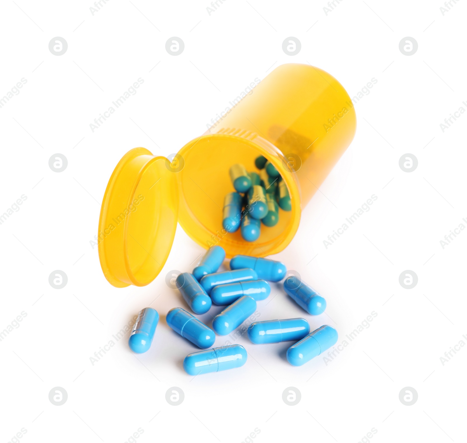 Photo of Plastic container with many light blue pills isolated on white
