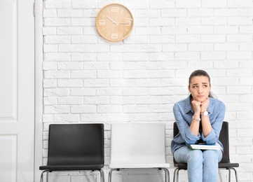 Young woman waiting for job interview, indoors