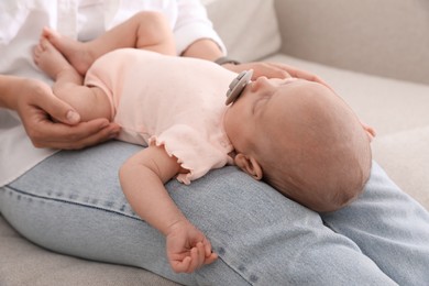 Photo of Mother with her cute sleeping baby on sofa, closeup