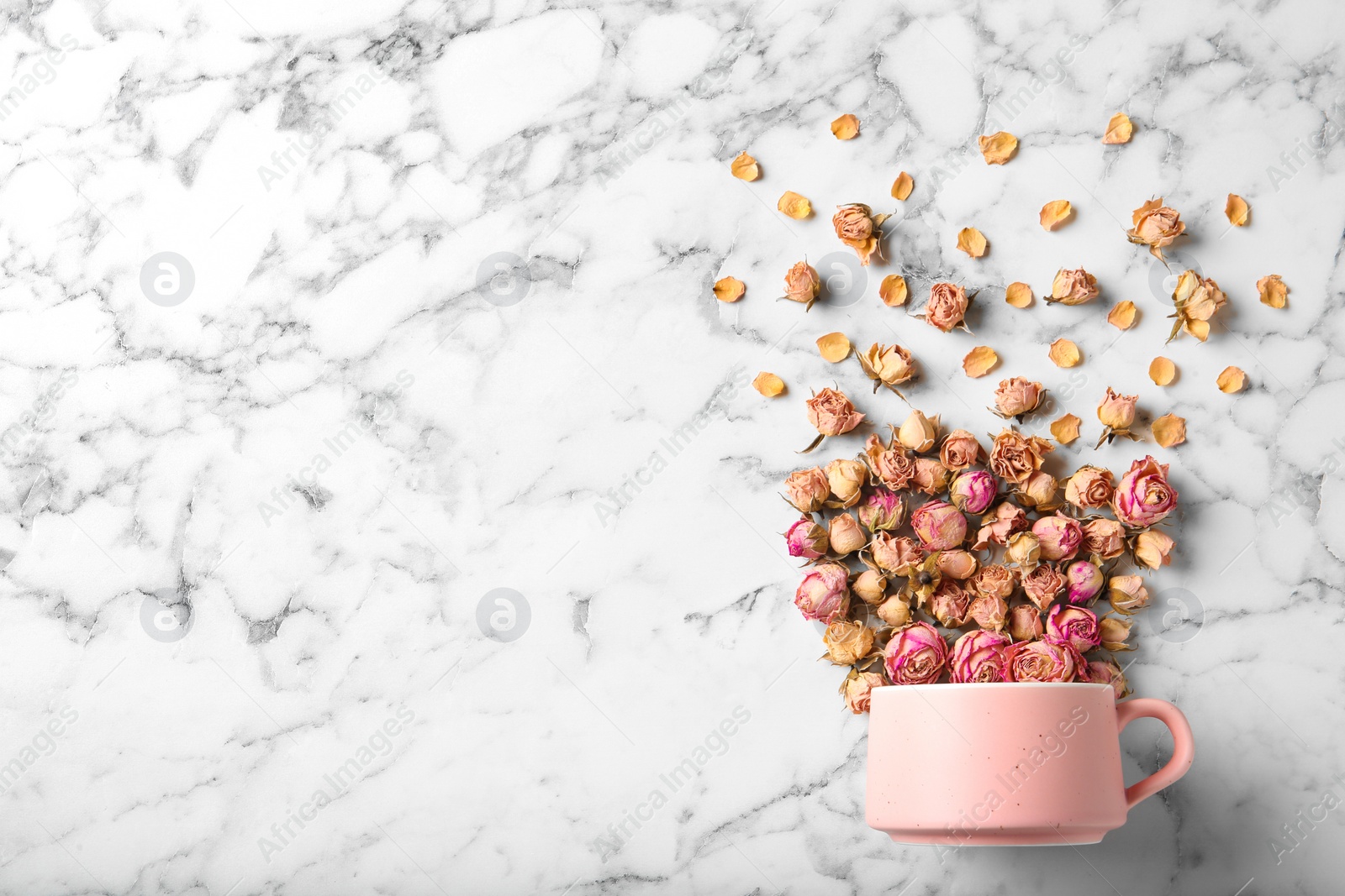 Photo of Flat lay composition with teacup and dried roses on marble background