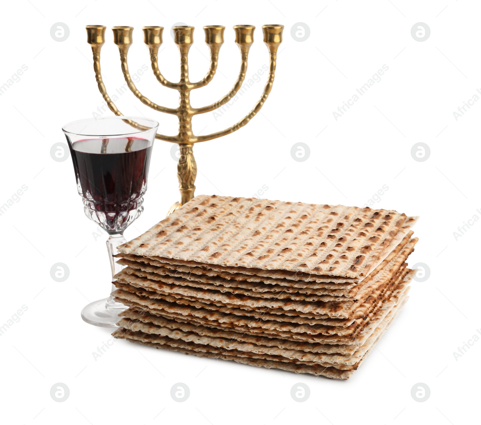 Photo of Traditional matzos, red wine and menorah on white background