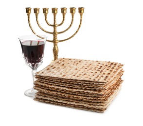 Photo of Traditional matzos, red wine and menorah on white background