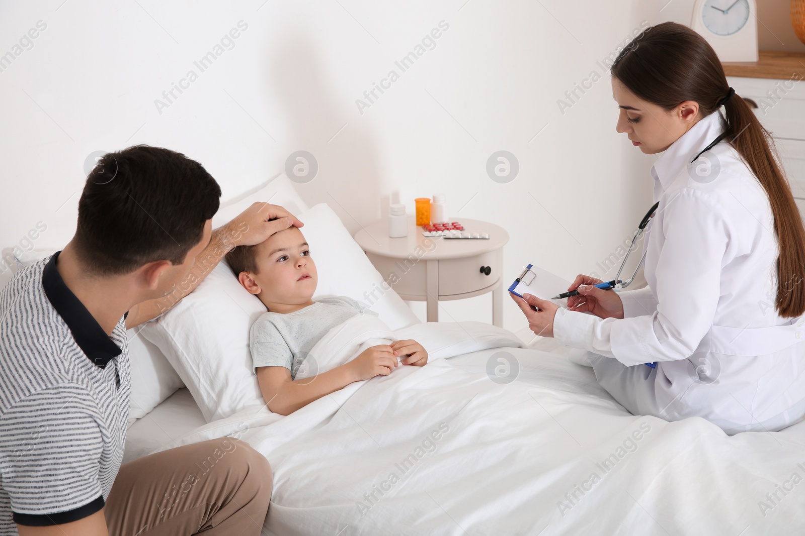 Photo of Children's doctor visiting little patient at home