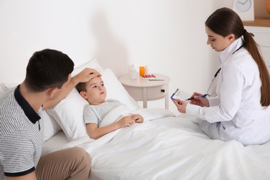 Children's doctor visiting little patient at home