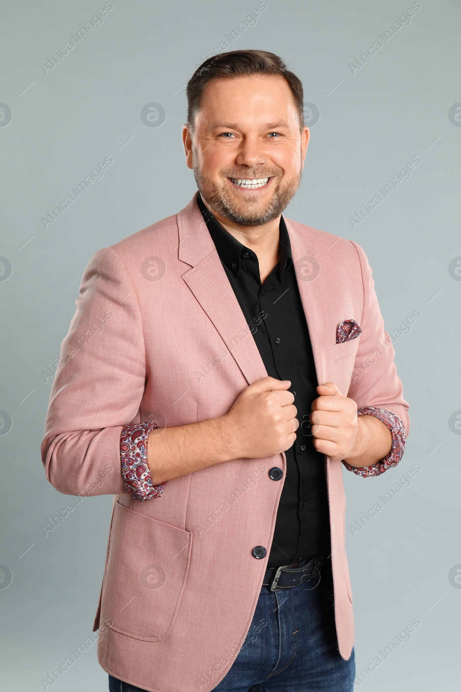 Photo of Portrait of happy mature man on light grey background