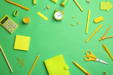 Photo of Frame of different bright school stationery on light green background, flat lay. Space for text