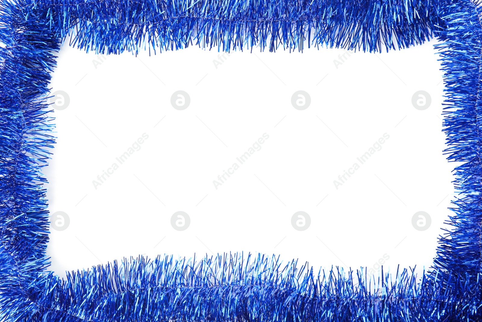 Photo of Frame of shiny blue tinsel on white background, top view. Space for text