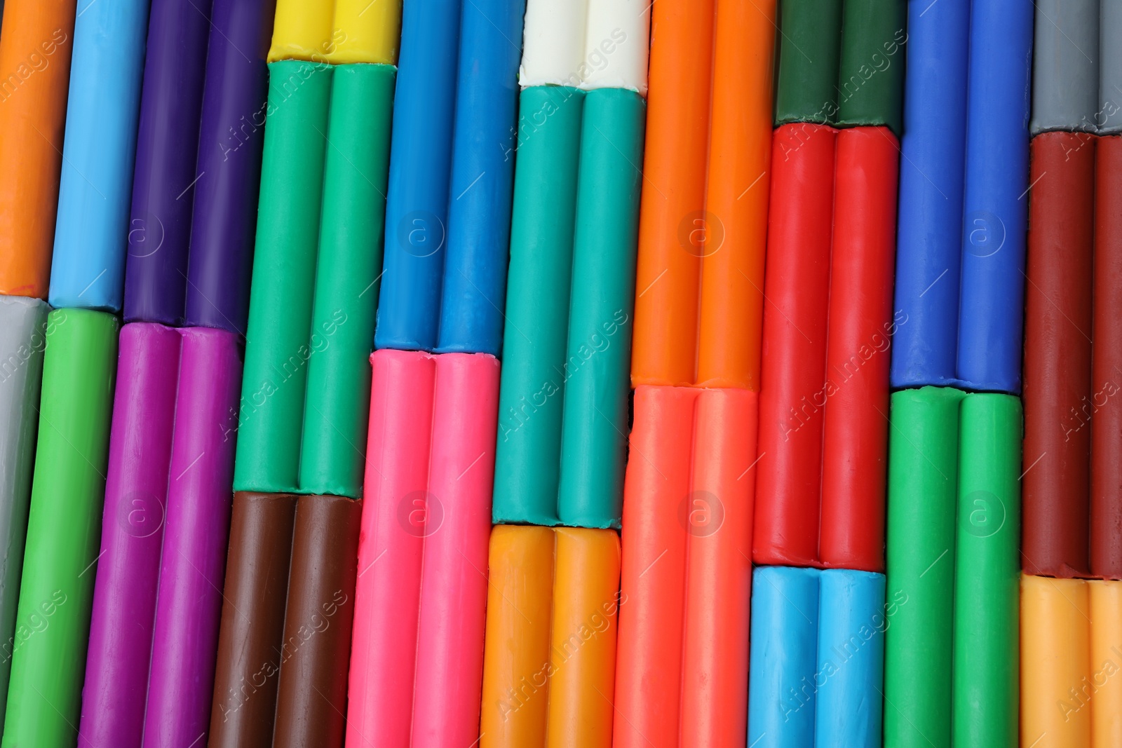 Photo of Many different colorful plasticine pieces as background, top view