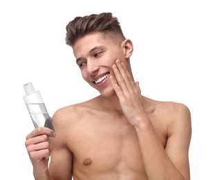 Photo of Handsome man applying lotion onto his face on white background