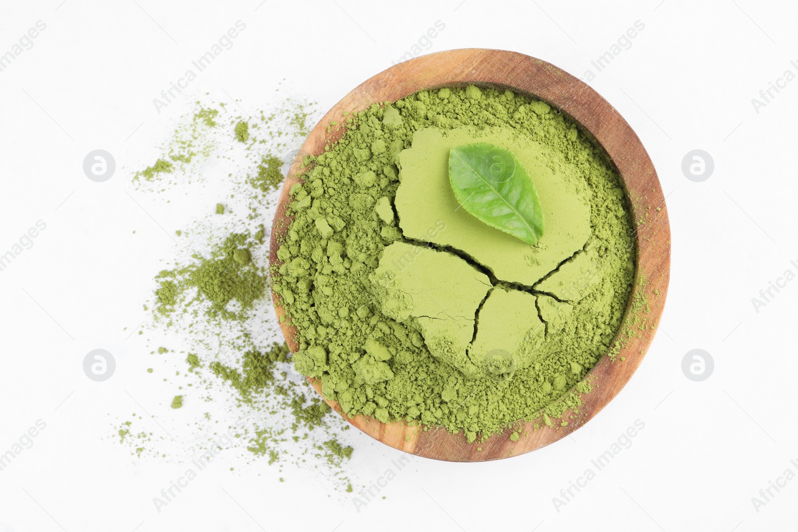 Photo of Bowl with matcha powder and leaf isolated on white, top view