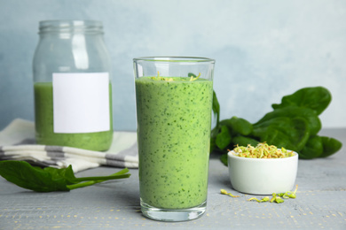 Green buckwheat smoothie on light grey wooden table