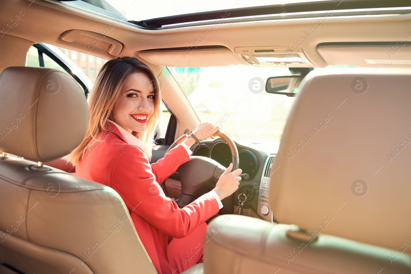 Photo of Young businesswoman on driver's seat of car