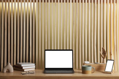 Stylish workplace with laptop and stationery on wooden table indoors