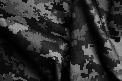 Image of Texture of crumpled camouflage fabric as background, top view. Black and white effect