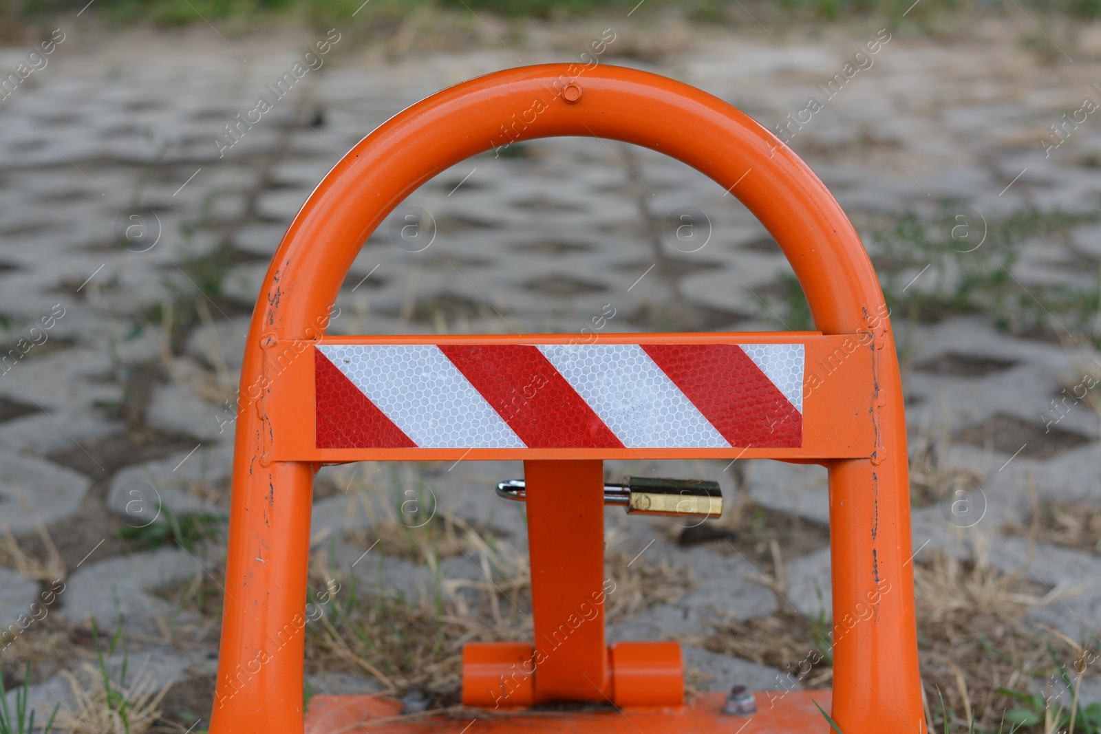 Photo of Barrier with No Parking sign on city street, closeup