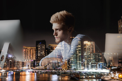 Image of Double exposure of young man working in office and night cityscape. Financial analytics