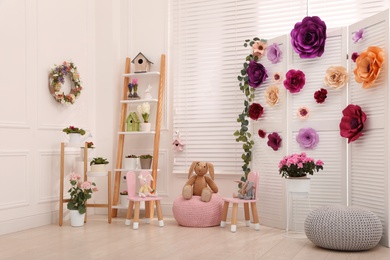 Easter photo zone with floral decor and chairs indoors