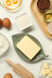 Photo of Flat lay composition with fresh butter among other products on white table