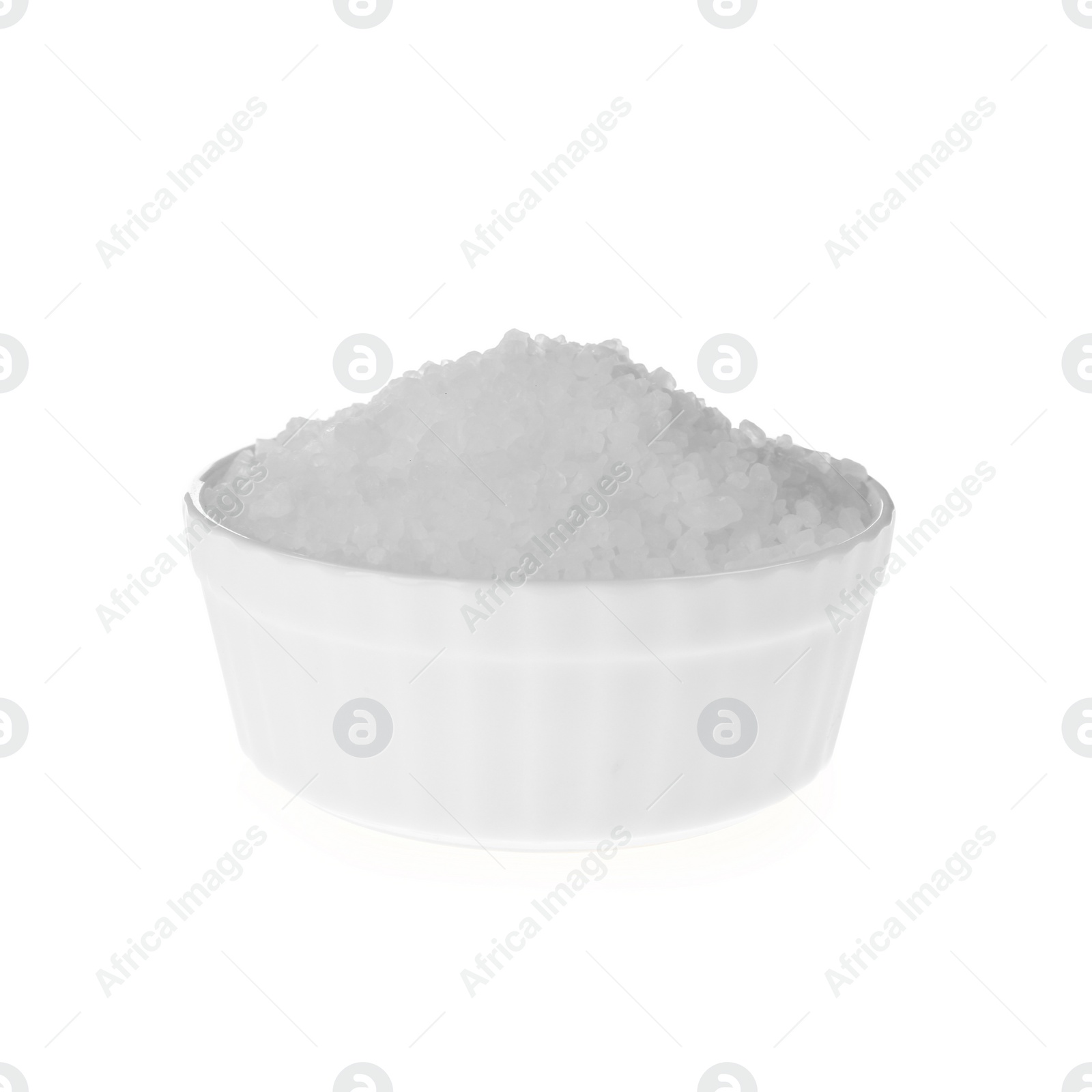 Photo of Natural salt in bowl on white background