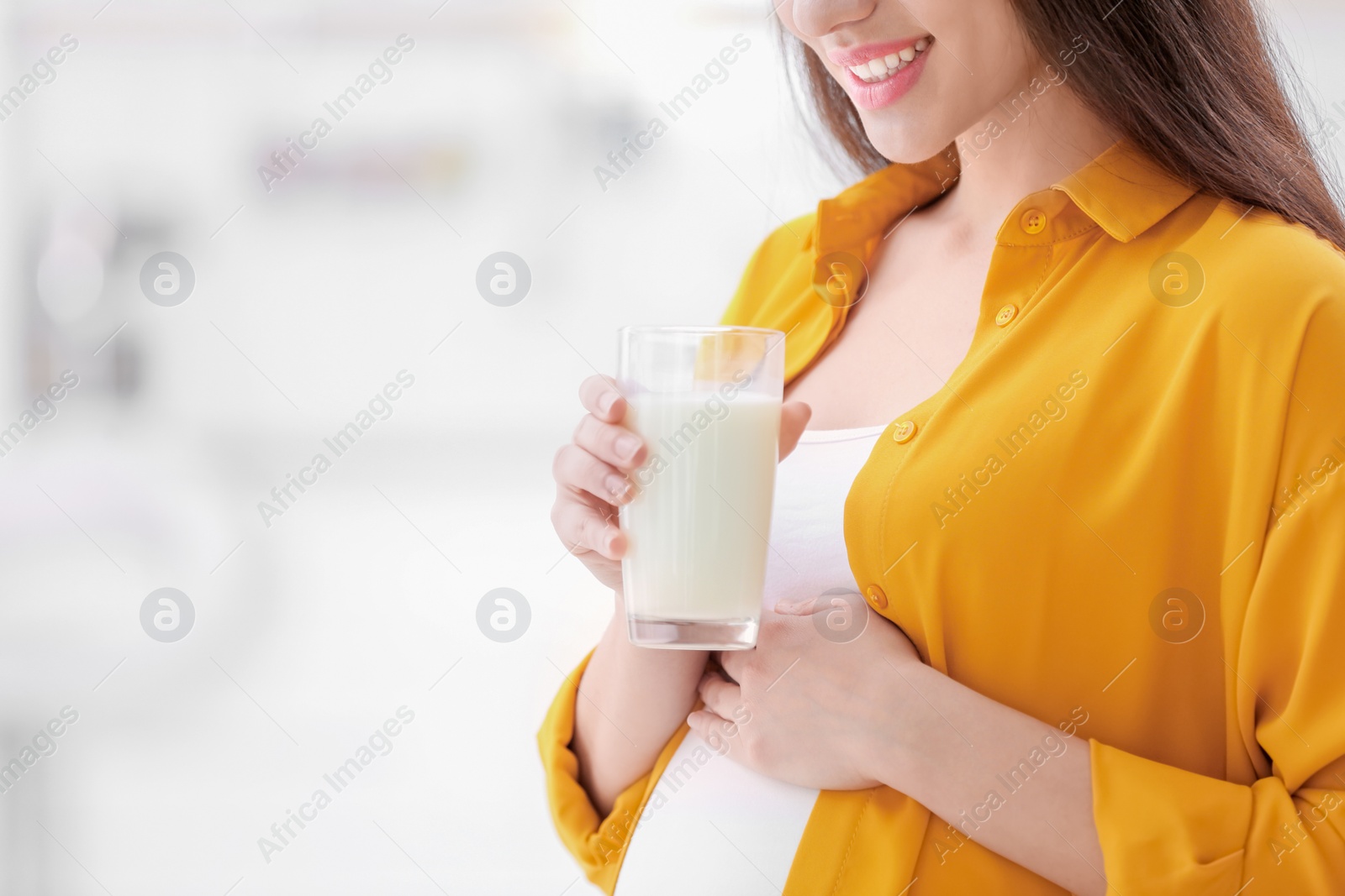 Photo of Beautiful pregnant woman drinking milk at home