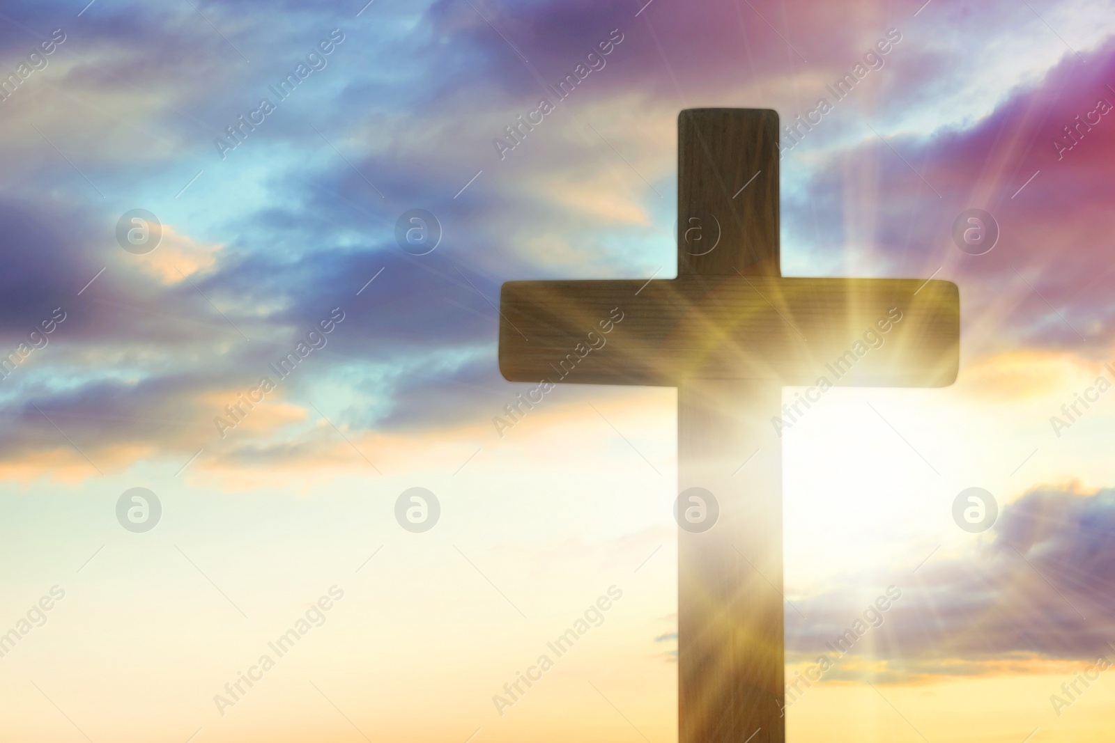 Image of Silhouette of cross against beautiful sky at sunrise. Christian religion