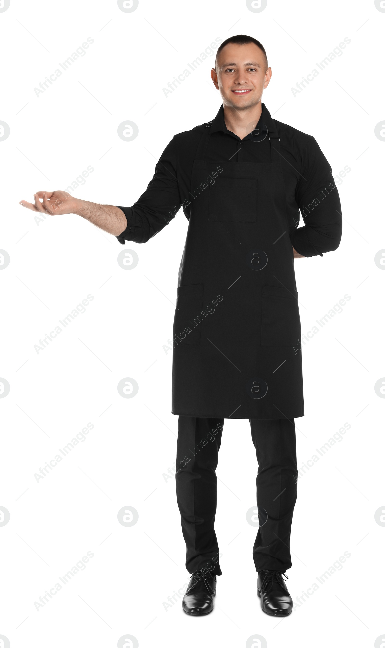 Photo of Full length portrait of happy young waiter in uniform on white background