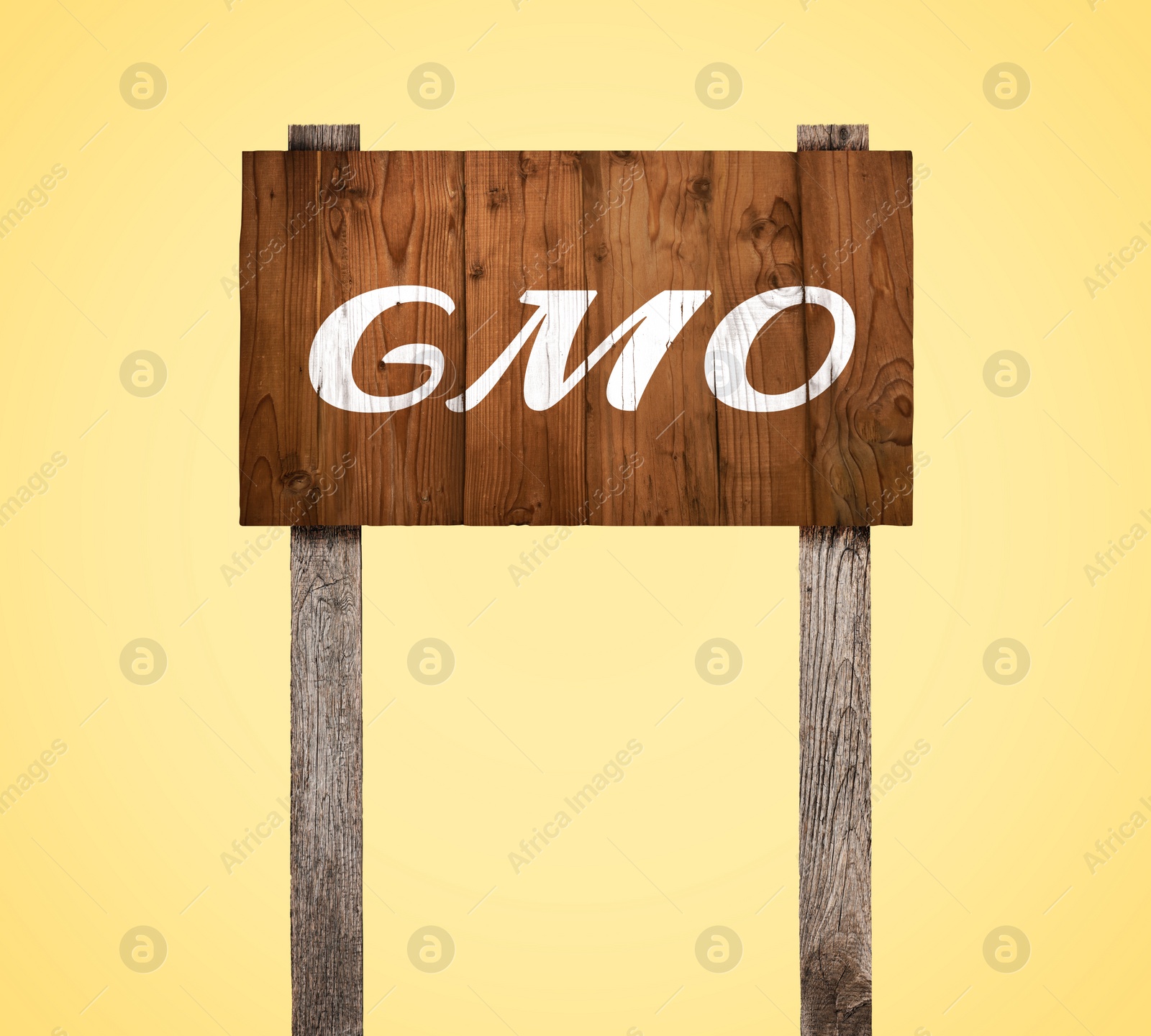 Image of Wooden sign with abbreviation GMO on beige background