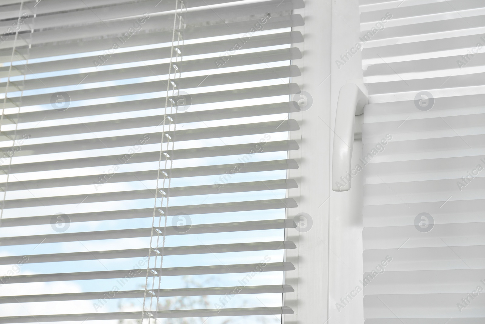 Photo of Window with modern horizontal blinds indoors