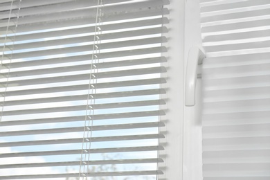 Photo of Window with modern horizontal blinds indoors
