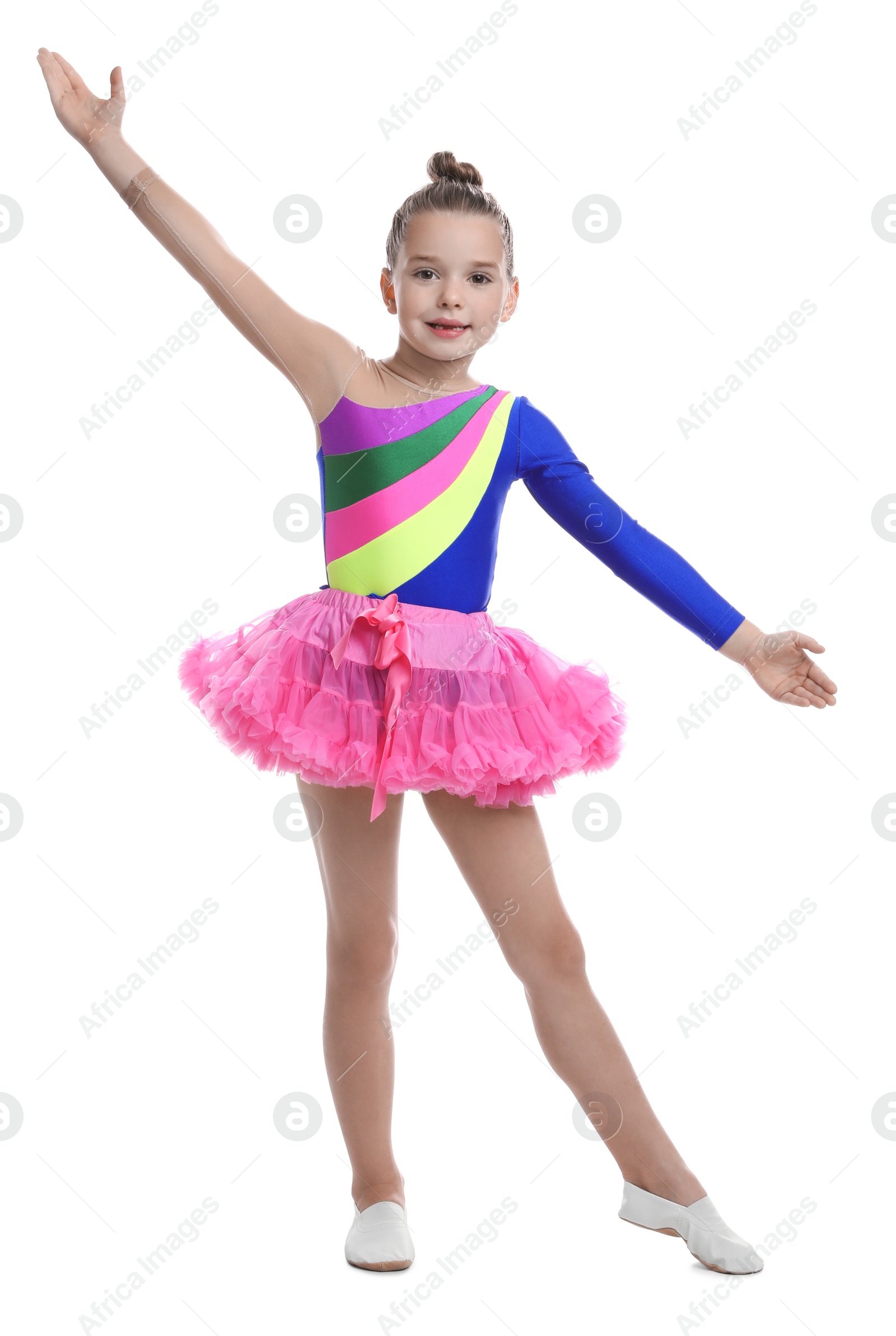 Photo of Cute little girl in costume dancing on white background