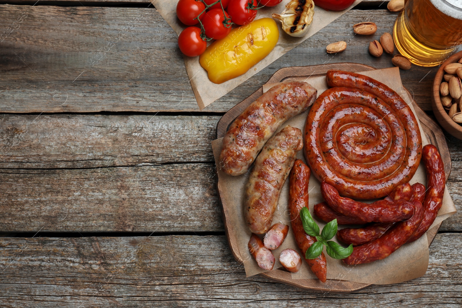 Photo of Set of different tasty snacks and beer on wooden table, flat lay