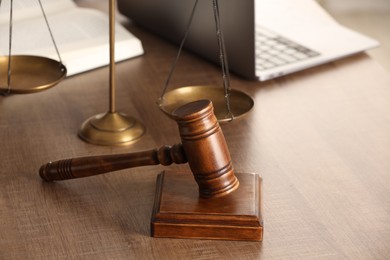 Photo of Law concept. Gavel, scales of justice, book and laptop on wooden table