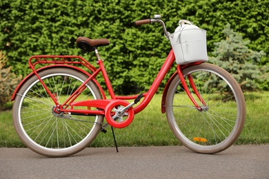 Photo of Modern color bicycle with basket in park