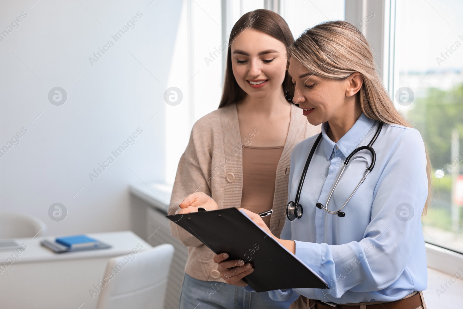 Photo of Professional doctor working with patient in hospital, space for text