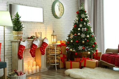 Stylish interior with Christmas tree and decorative fireplace