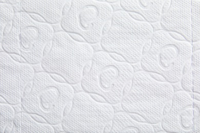 Photo of Toilet paper with pattern as background, closeup