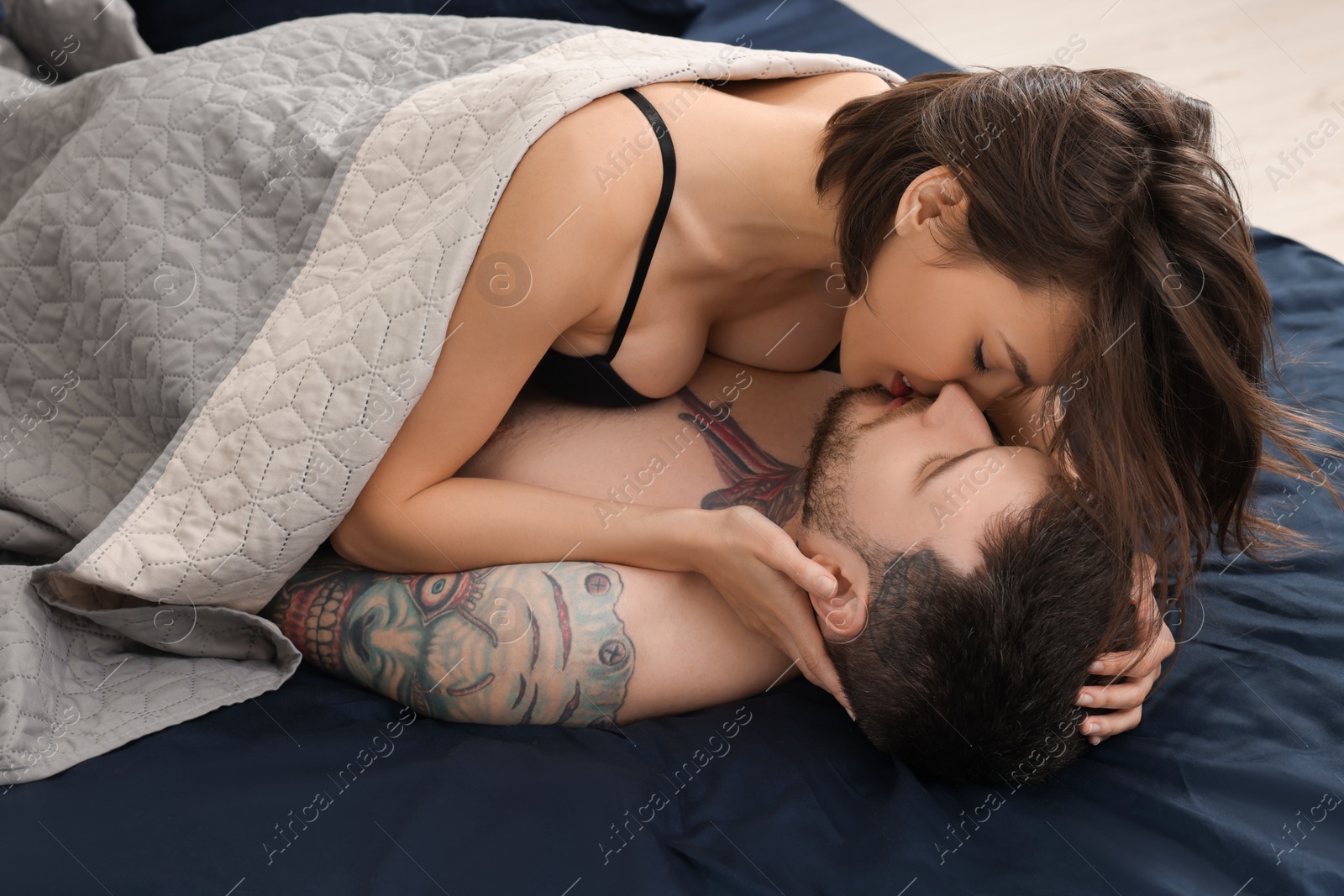 Photo of Passionate young couple having sex on bed