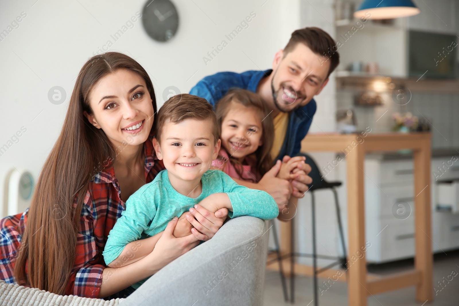 Photo of Happy family with cute children on sofa indoors