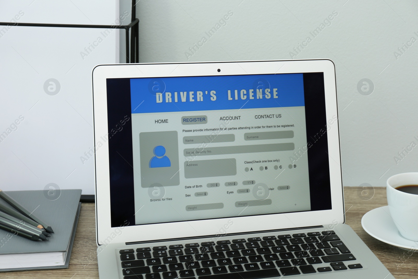 Photo of Laptop with driver's license application form on table in office