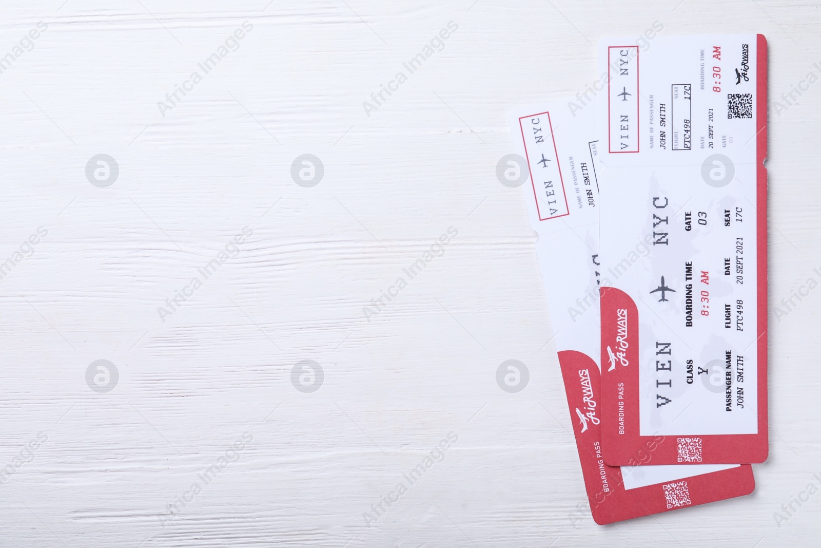 Photo of Tickets on white wooden table, flat lay with space for text. Travel agency concept