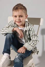 Fashion concept. Stylish boy on light grey background