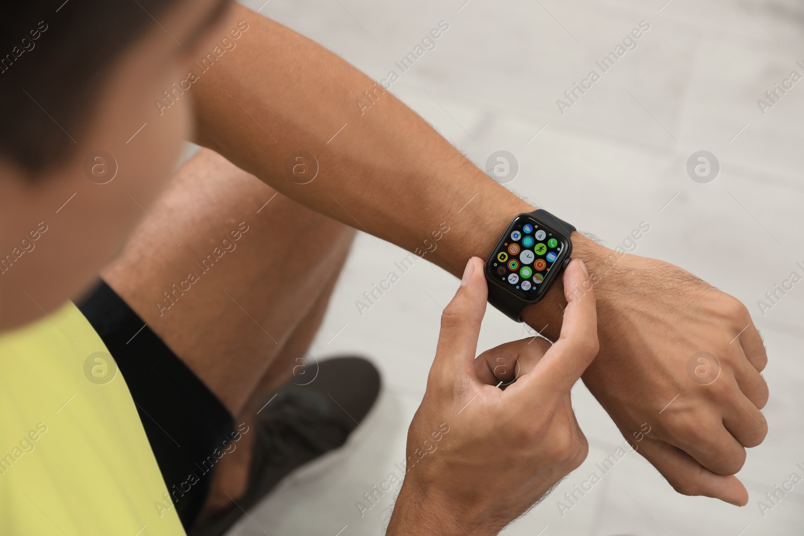 Image of MYKOLAIV, UKRAINE - OCTOBER 04, 2019: Man using Apple Watch at home, closeup