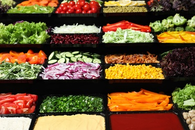 Salad bar with different fresh ingredients as background