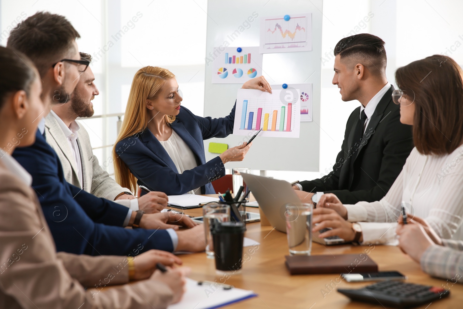 Photo of Businesspeople having meeting in office. Management consulting