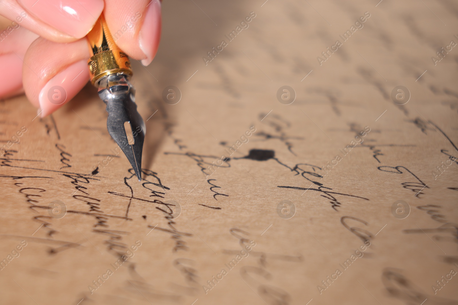 Photo of Woman writing letter with fountain pen, closeup