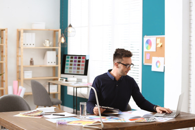 Photo of Professional interior designer at workplace in office