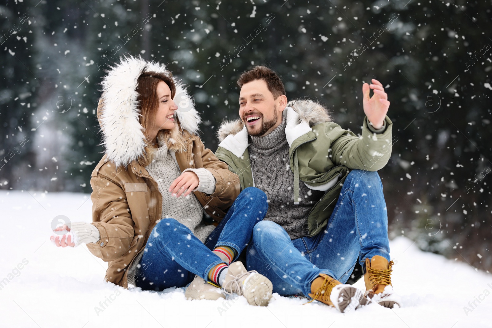 Photo of Couple spending time outdoors on snowy day. Winter vacation