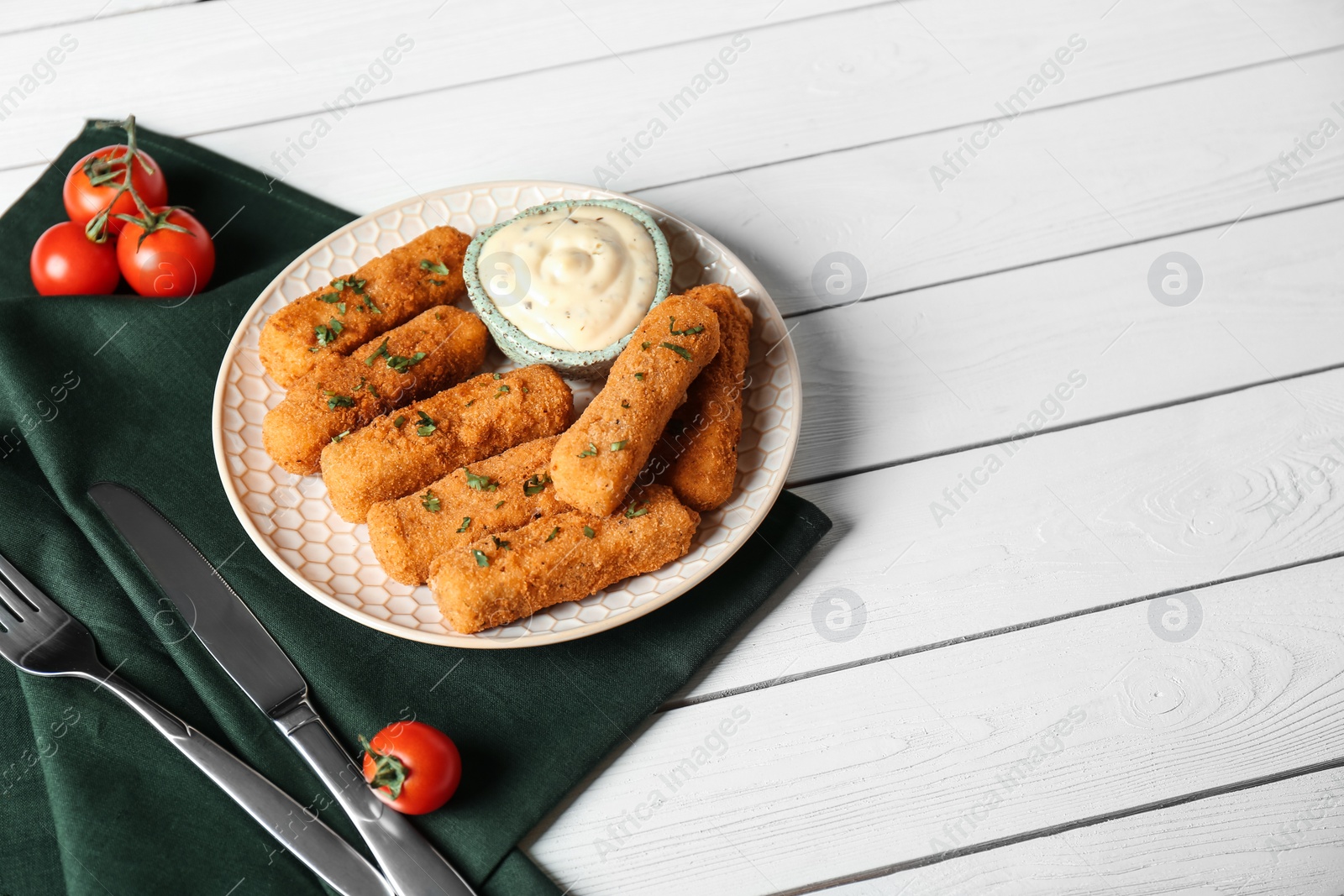 Photo of Plate of cheese sticks and sauce served on table. Space for text